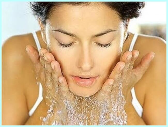 Mujer lavándose la cara para combatir el acné 
